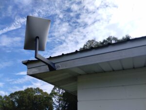 Home with Starlink antenna Mounted to the Fascia Board and cable point of entry through the attic