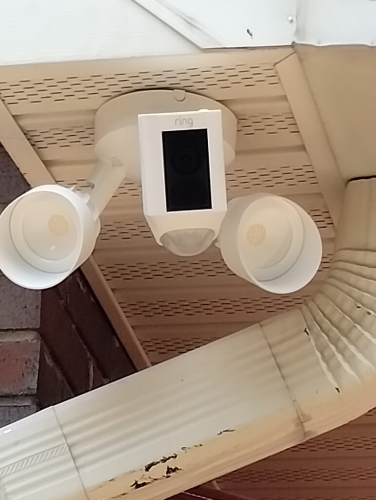 A ring Ring Camera mounted to the corner of a home by Jae-Tech llc